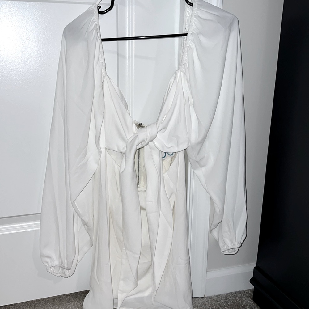 Great for brides! Tie front closure, zippered back, sheer long sleeve